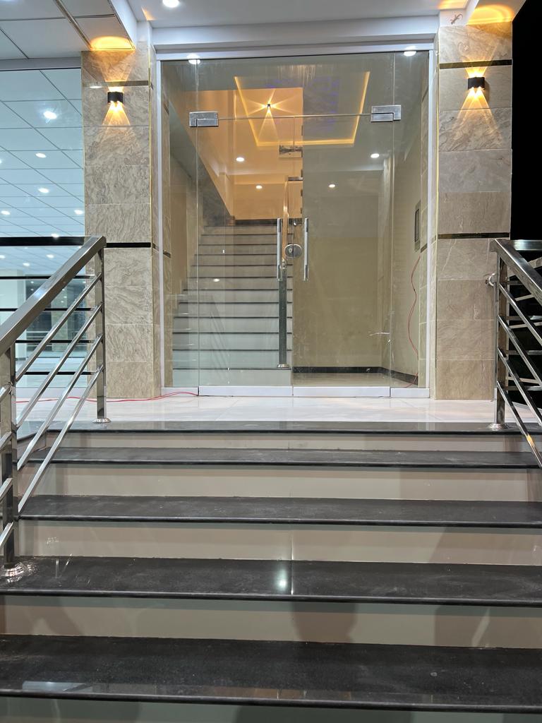 Karachi Office construction - Empty workspace floor showing columns and tile work